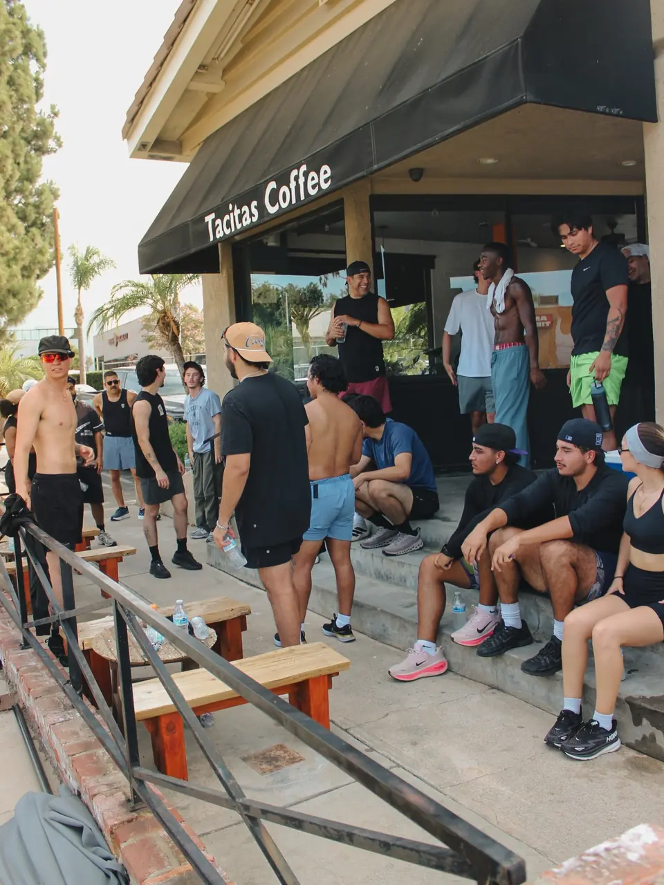 Runners resting on the steps and benches after the run, water bottles in hand